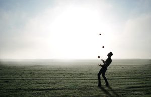 Juggler on a beach juggling three balls